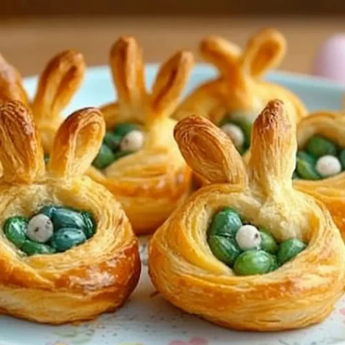 Savory Easter bunny crescent bites filled with spinach and cheese, shaped like bunny heads with puff pastry ears.