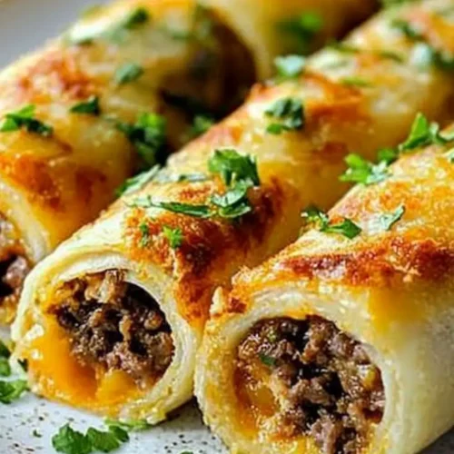Low-carb Keto Philly Cheesesteak Roll Ups  with melted cheese and ground beef filling