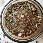 Glass bowl filled with aromatic spaghetti seasoning blend made from dried herbs and spices